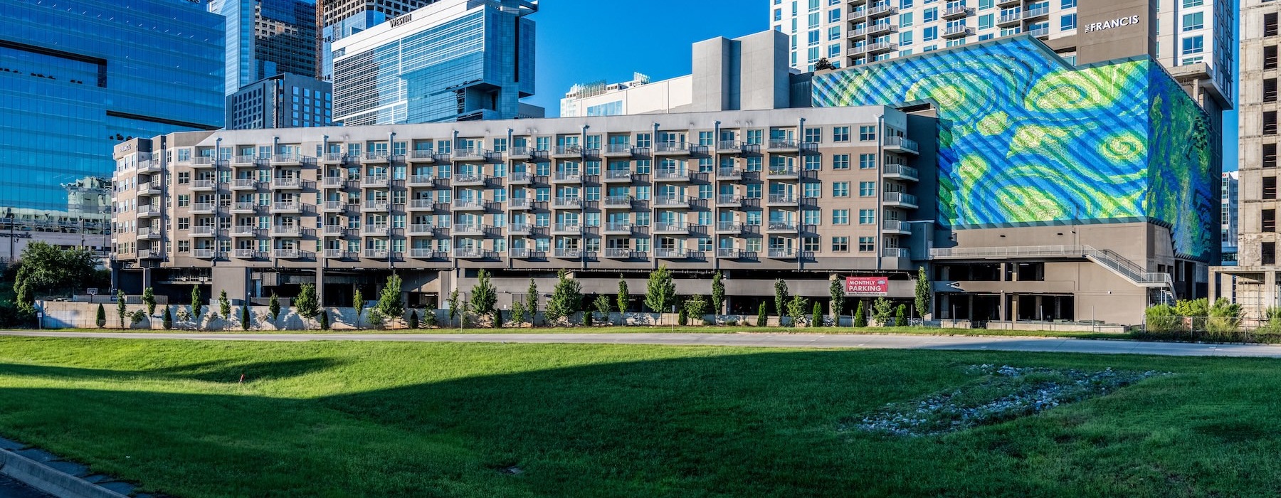 a large building with a lawn in front of it