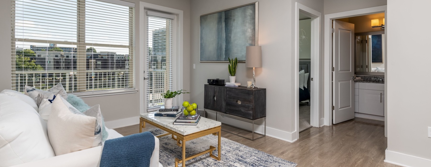 living room with a couch and coffee table and large windows