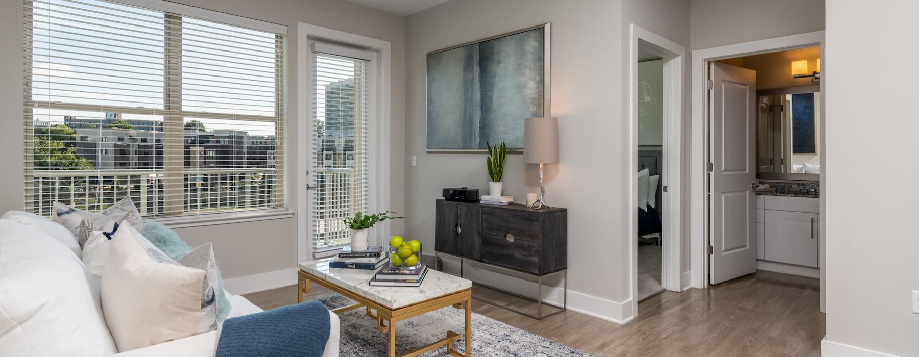 living room with a couch and coffee table and large windows