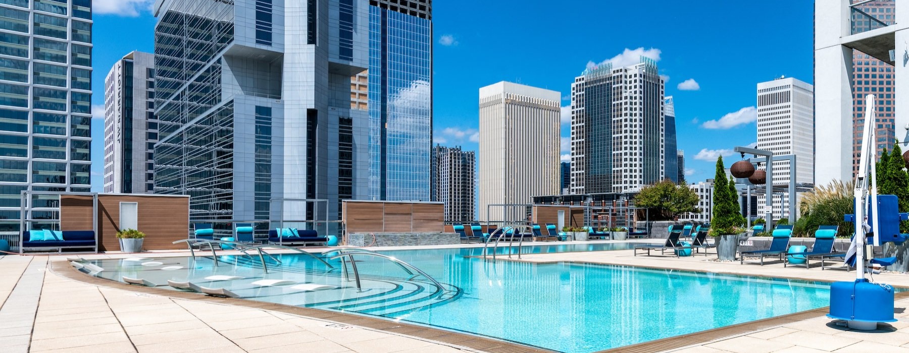 a large swimming pool in front of a city view