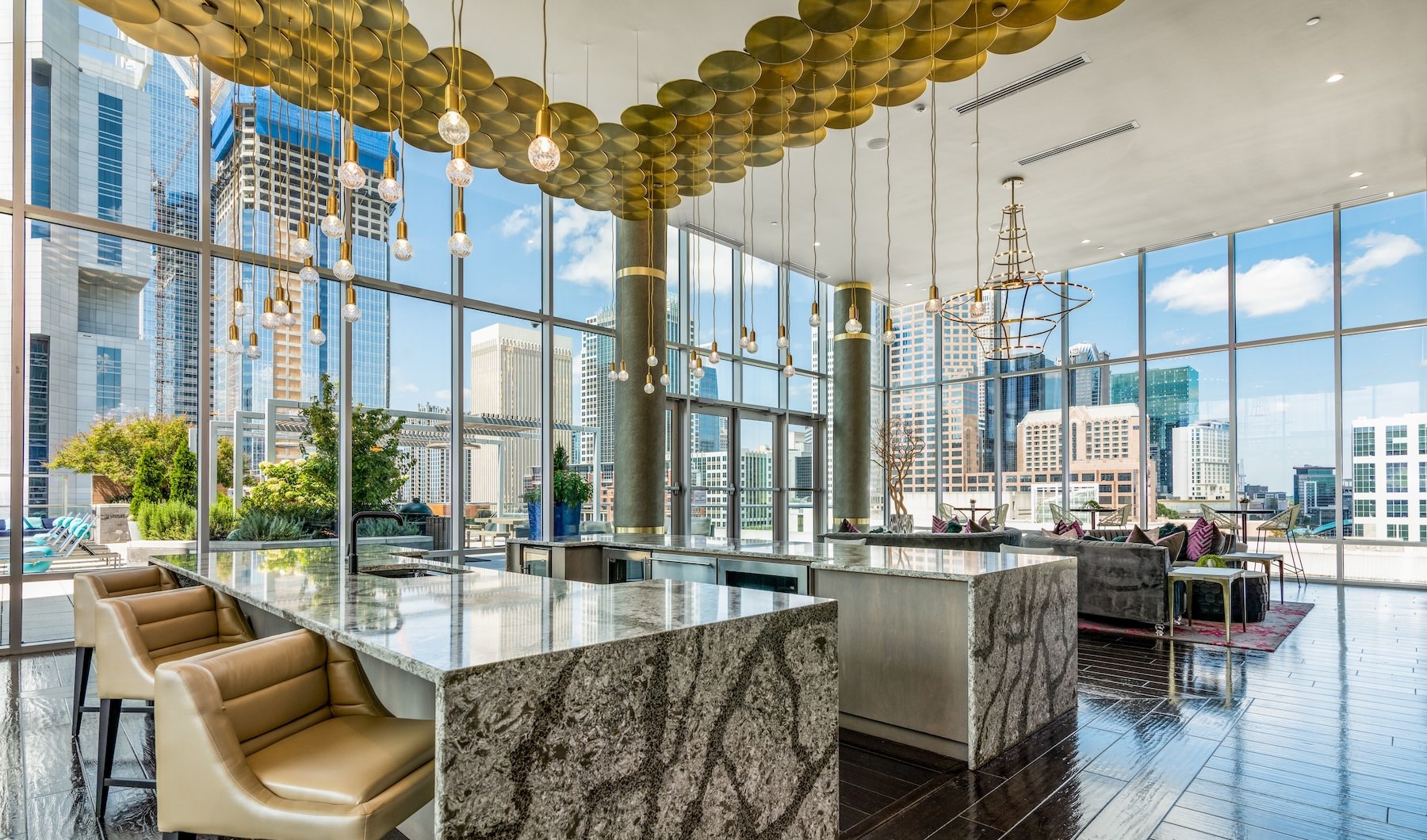 spacious lounge with many large windows overlooking a city skyline