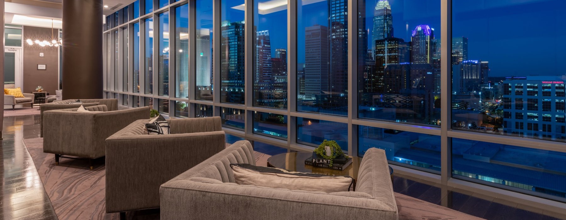 a room with large windows with a view of the city