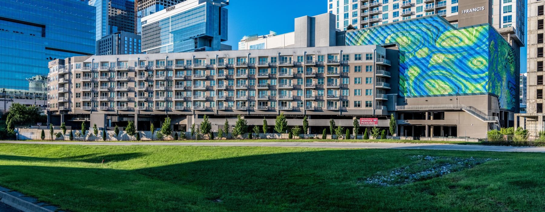 a large building with a lawn in front of it